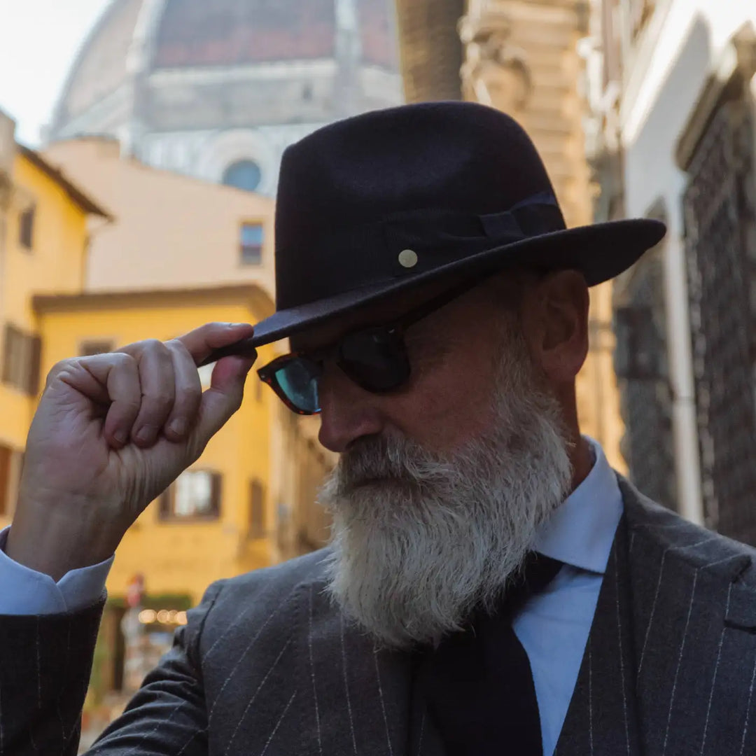 modello maturo distinto con cappello fedora coccos primario nesti in lana merinos nel suo outfit invernale con classe italiana