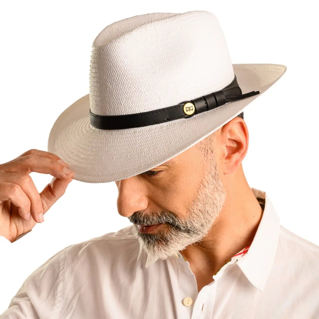primo piano frontale inclinato di uomo con barba che indossa un cappello da sole in stile fedora estivo color bianco fatto da cappelleria primario nesti