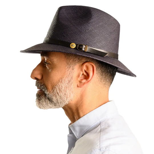 primo piano laterale di un signore adulto con barba che indossa un cappello di panama a tesa media da sole color blu realizzato da cappelleria primario nesti