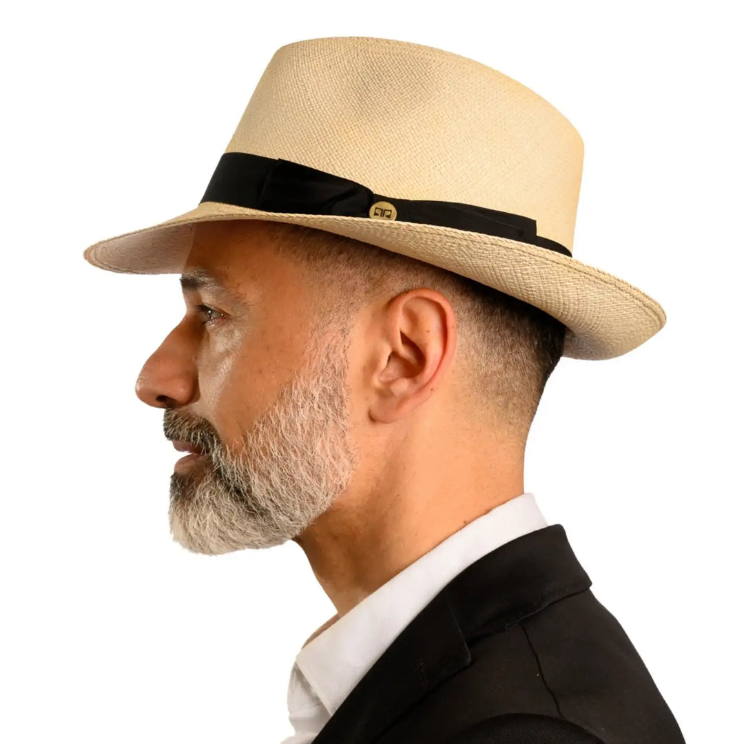 primo piano laterale di un signore adulto con barba che indossa un cappello di panama montecristi originale color natural realizzato da cappelleria primario nesti